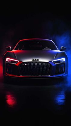 an audi sports car in the dark with blue and red lights