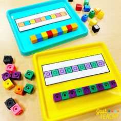 two trays with different colored lego blocks on top of a table next to each other