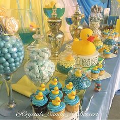 a table topped with lots of cupcakes and candy