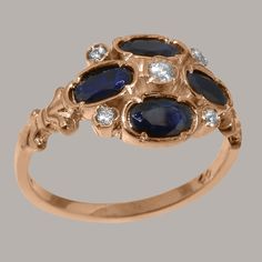 "A romantique style nine stone ring with delicate fleur de lis design on the shoulders. The Sapphires are 5x4mm oval shaped, the center Cubic Zirconia are 2.75mm and 1.5mm round. We use Natural Sapphires which have been carefully chosen for this ring by expert Jewellers to ensure a good fit. The Sapphire stone has a beautiful night sky blue colour which is elevated by the sparkle of these clear white Cubic Zirconia enhancing the Sapphires and unveiling their full beauty. This design is made up o Red Ring Box, Sky Blue Colour, Beautiful Night Sky, Beautiful Night, Clear White, Sapphire Stone, Natural Sapphire, Blue Colour, Cluster Ring