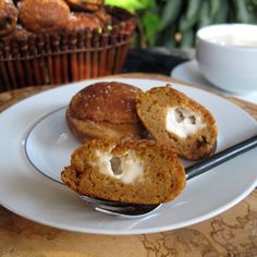 two muffins are on a plate with a fork