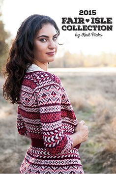 a woman standing in a field wearing a red and white sweater