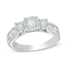 three stone engagement ring with diamonds on the band and shoulders in 18k white gold