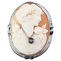 14 Karat White Gold Cameo Brooch/Pin- This elegant cameo features a lovely lady in profile framed in beautifully detailed 14K white gold filigree. Accented with one round single cut diamond. Approximate total diamond weight: .01 ct. Diamond color: I Diamond clarity: I2 Size: 43 mm x 34 mm Weight: 4.5 dwt. / 7.1 gr. Stamped: 14K Very good condition, professionally polished. Will come packaged in a gift box or pouch (when possible) Retro Ring, Cameo Jewelry, Carved Shell, Cameo Brooch, Pin Pendant, Ruby Lane, Estate Jewelry, Vintage Brooches, White Gold Diamonds