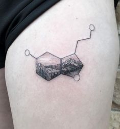 a woman's thigh with an image of mountains in the shape of hexagons