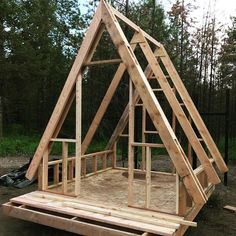 a frame house built in the woods with wood framing and roof trusses on top