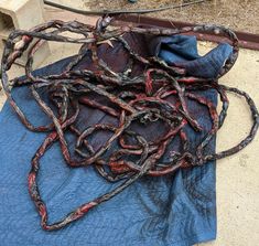 a pile of metal chains sitting on top of a blue cloth next to a fire hydrant