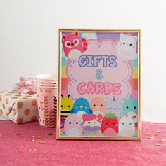 a pink table with gifts and cards on it