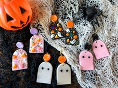 halloween themed earrings are laying on the ground