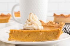 a slice of pumpkin pie with whipped cream on top