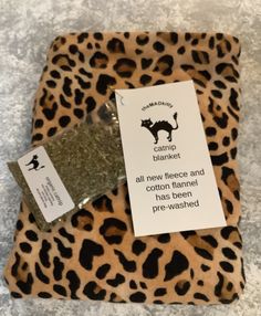 a leopard print tray with a label on it that says,'all new fleece and cotton tarnished the wash - washed