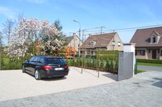 a black car parked in front of a house