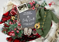 a baby's sweater and booties are laid out next to a christmas cardigan