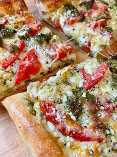 several slices of pizza with various toppings on a cutting board