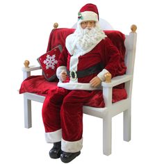 a santa clause sitting in a chair with his legs crossed