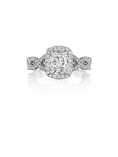 a cushion cut diamond ring with three pave diamonds