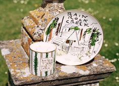 a plate and cup sitting on top of a rock