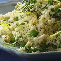 a close up of a plate of food with rice and peas