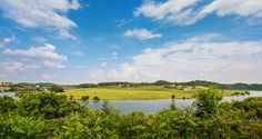 a river running through a lush green countryside