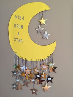 a yellow moon and stars hanging from the side of a wall with wish upon a star written on it