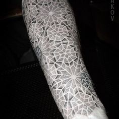 the arm is covered with intricate lace and has an ornate design on it's side