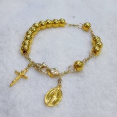 This bracelet has designed by Korea catholic person for her husband. She sugested all destails including cross and miraculous pendant. 24k gold 7mm ball has weaved by 18k solid gold wire and 18k gold chains. For the safety reason, 18k gold clasp & 18k gold chain has to be used. Customer can select different style and any changes is possible. Short wrist cannot use 15 pcs of 24k gold ball but 11 pcs is suitable. I do not accept off-site ads order. * Material : 24K Solid gold & 18k solid g Elegant 8mm Beads Jewelry For Blessing, 8mm Beads Bracelet For Blessing, Spiritual Gold Bracelet With Round Beads, 8mm Beaded Bracelets For Blessings, Spiritual Yellow Gold Bracelet, Adjustable Yellow Gold Rosary Bracelet, Adjustable Gold Dainty Rosary Bracelet, Gold Bracelet With 8mm Beads, 14k Gold Filled, Rosary Bracelet With Gold Round Beads As Gift