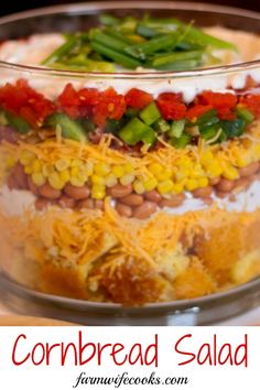 a layered salad in a glass dish on a table