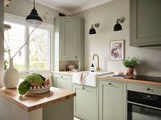 an image of a kitchen setting with green cabinets