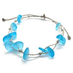 Gorgeous beach bracelet or anklet made with turquoise blue and white sea glass pebbles on our durable hand spun rope cord. Pure island style! Easy and secure adjustable slide knot closure allows for easy on and off. This bracelet/anklet is completely waterproof and metal free making it perfect for anyone with skin sensitivities and is a wonderful and unique gift for those hard to shop for friends and family on your list, especially the beach lovers! Color: Turquoise blue Size: Available in three Adjustable Blue Beach Jewelry, Adjustable Blue Jewelry For Beach, Adjustable Blue Strand Jewelry, Adjustable Recycled Glass Bracelets As Gift, Adjustable Blue Beachy Jewelry, Blue Adjustable Beachy Jewelry, Blue Jewelry With Adjustable Cord For Beach, Blue Jewelry With Adjustable Cord For Vacation, Blue Adjustable Cord Jewelry For Vacation