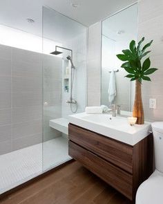 a bathroom with a sink, mirror and shower in it's centerpieces