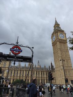 the big ben clock tower towering over the city of london on a gloomy day