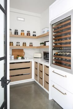 a kitchen filled with lots of wooden shelves