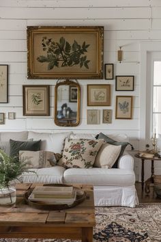 Cozy farmhouse living room featuring a white sofa, wooden table, and a wall adorned with botanical prints for rustic wall decor ideas. Farmhouse Living Room Wall Decor, Wall Art Living Room, Wall Decor Living Room, Open Space, Rustic Charm, Farmhouse, Wall Decor, Living Room, Wall Art