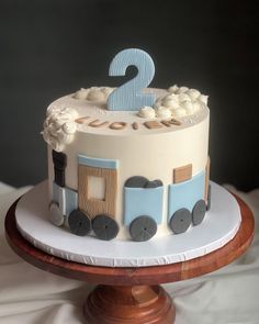 a birthday cake with a train on top and the number two on it's side