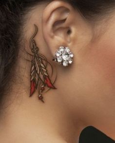 a close up of a woman's ear with some piercings on her ears