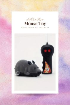 a mouse toy sitting next to a black object on top of a purple and pink background