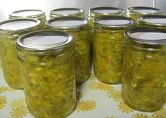 there are many jars with pickles in them