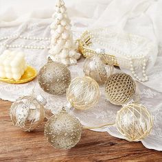 some ornaments are sitting on a lace doily