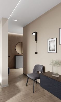 a chair sitting on top of a hard wood floor next to a wall mounted clock