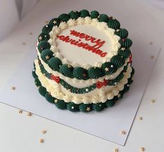 a decorated christmas cake sitting on top of a table