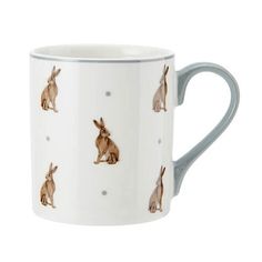 a coffee mug with rabbits on it