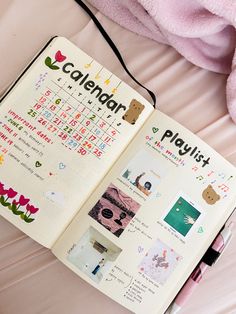 an open calendar book sitting on top of a bed next to a pink blanket and teddy bear