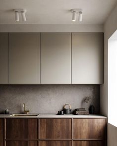 a kitchen with wooden cabinets and white counter tops