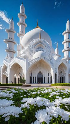 white flowers in front of a large building with many spires and domes on it