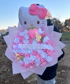 a hello kitty stuffed animal holding a bouquet of roses with the words i love you written on it