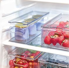 an open refrigerator filled with lots of different types of fruits and veggies in containers