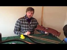 a man standing in front of a model train set