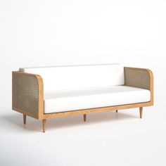 a white couch sitting on top of a wooden frame