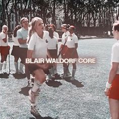 a group of women standing around each other on a field