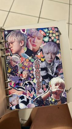 a person holding up a spiral notebook with images on it and the words bts